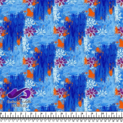 Abstract blue textured fabric with white and purple snowflakes and orange